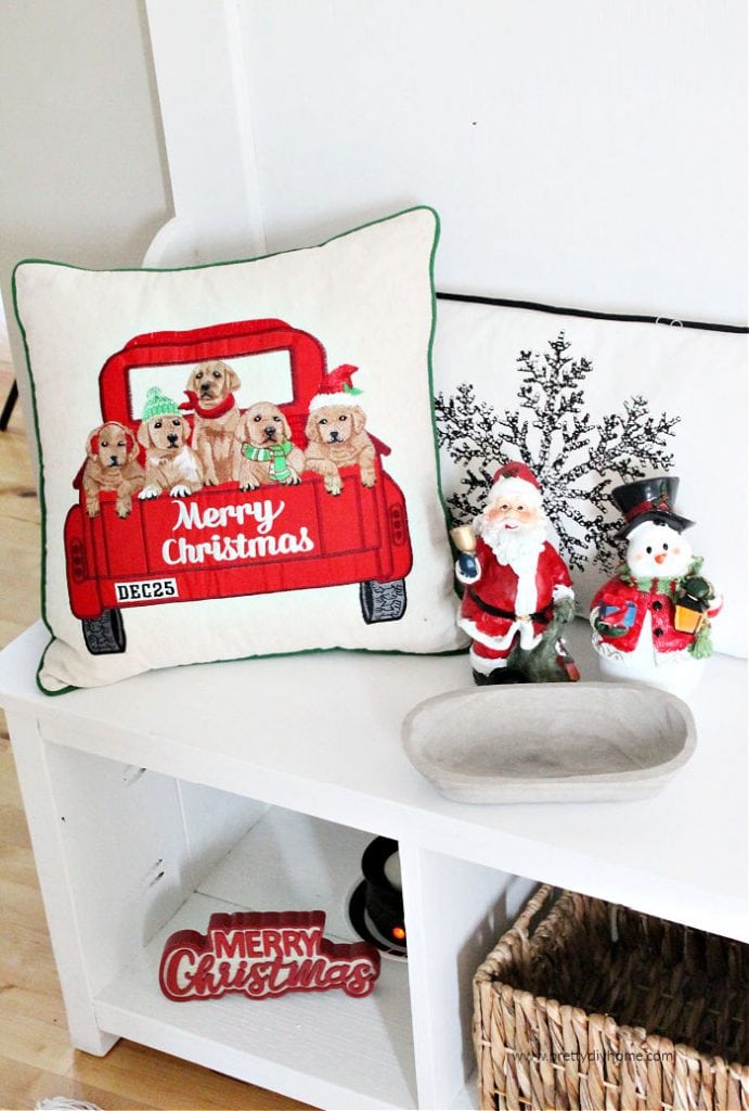 A DIY farmhouse hall tree decorated with cushions and baskets for Christmas.