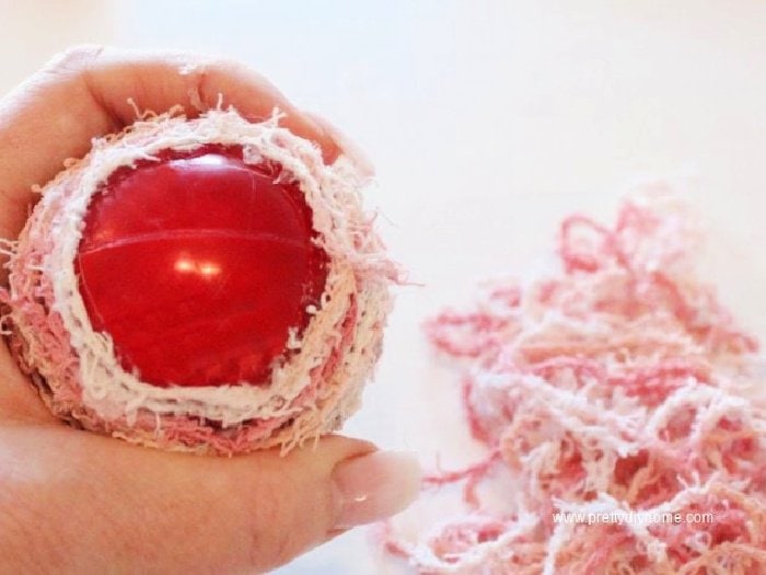 The underside of a DIY Christmas ornament made with wool and dollar tree Christmas ornament.