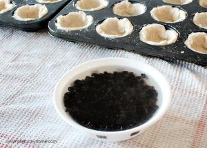 A bowl of currents being softened in boiling water while making butter tarts.