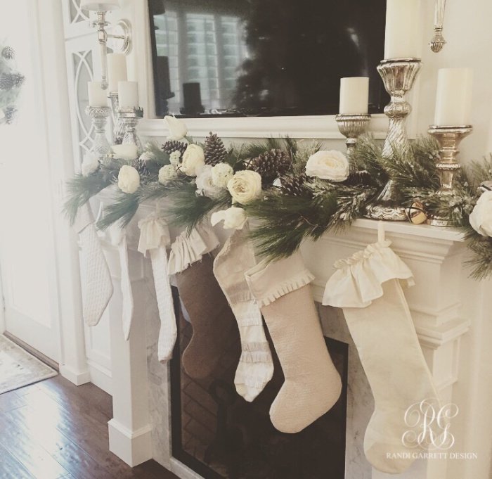 White Christmas mantel with white Christmas stockings and white roses