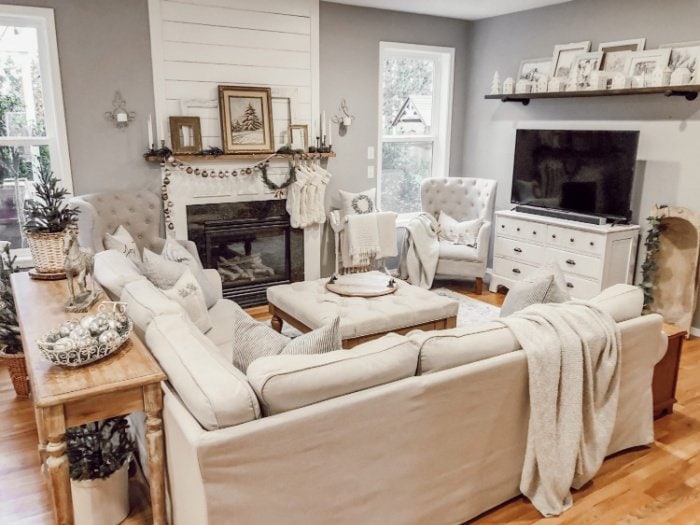 Cozy and comfortable living decorated in White for Christmas with cream throws.