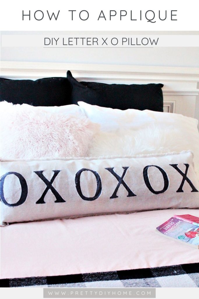 A handmade xo pillow thats been reversed appliqued for an easy method and more modern style.  The long xox cushion is sitting on a bad with pink bedding.