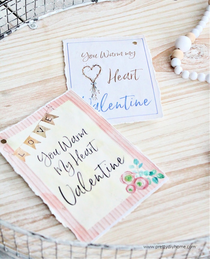 Two free printable valentine cards one pink and one soft blue. Both say your warm my heart Valentine.