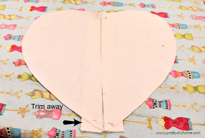 The front piece of a DIY valentine heating pad with a pleat in the front. It is made of drop cloth.