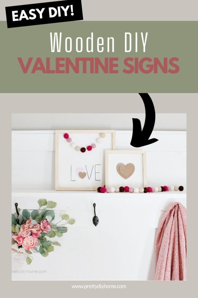 Two farmhouse DIY Wooden Valentine signs made with paint and a free pattern. One sign says love and the second sign is smaller with a neutral beige valentine center. Both are sitting on a white wood shelf on a hall tree.