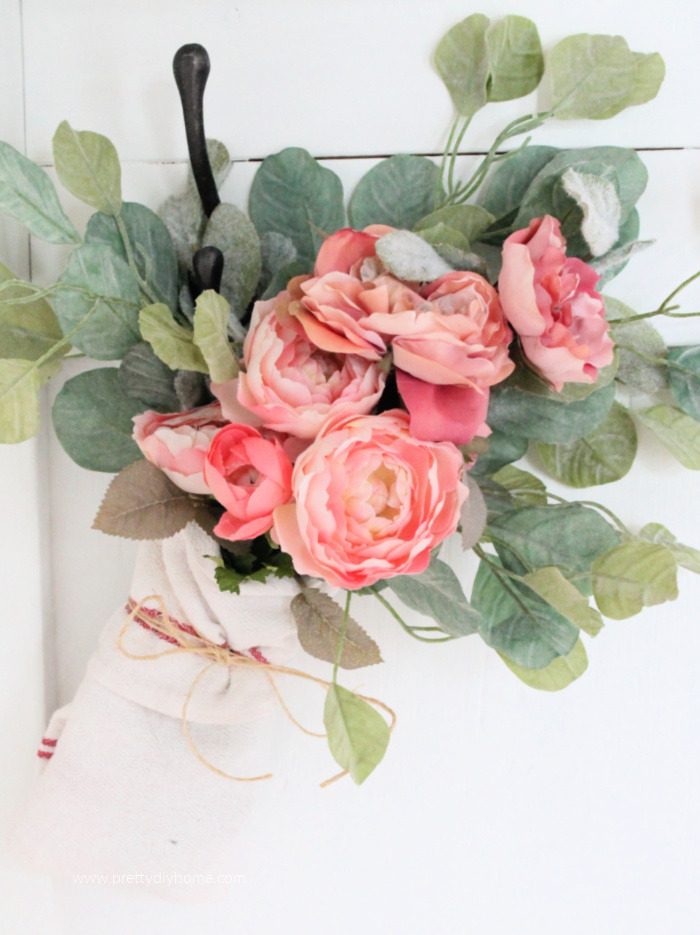 A pink Ikea Flower arrangement with greenery, wrapped in a bundle and tied with twine. A pretty farmhouse flower arrangment you can use for Valentines day or into Spring.