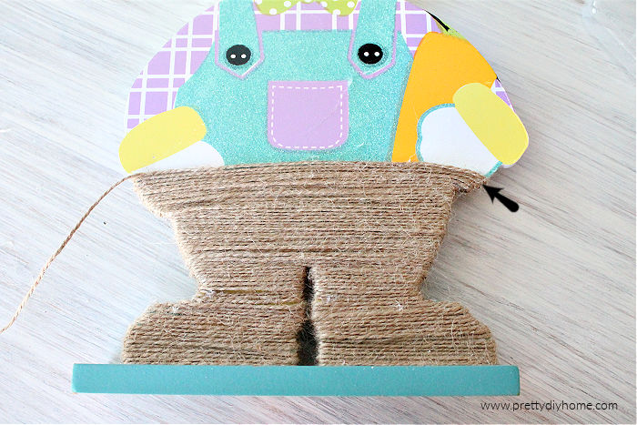 Wrapping a dollar store Easter bunny in twine for neutral farmhouse Easter decor.