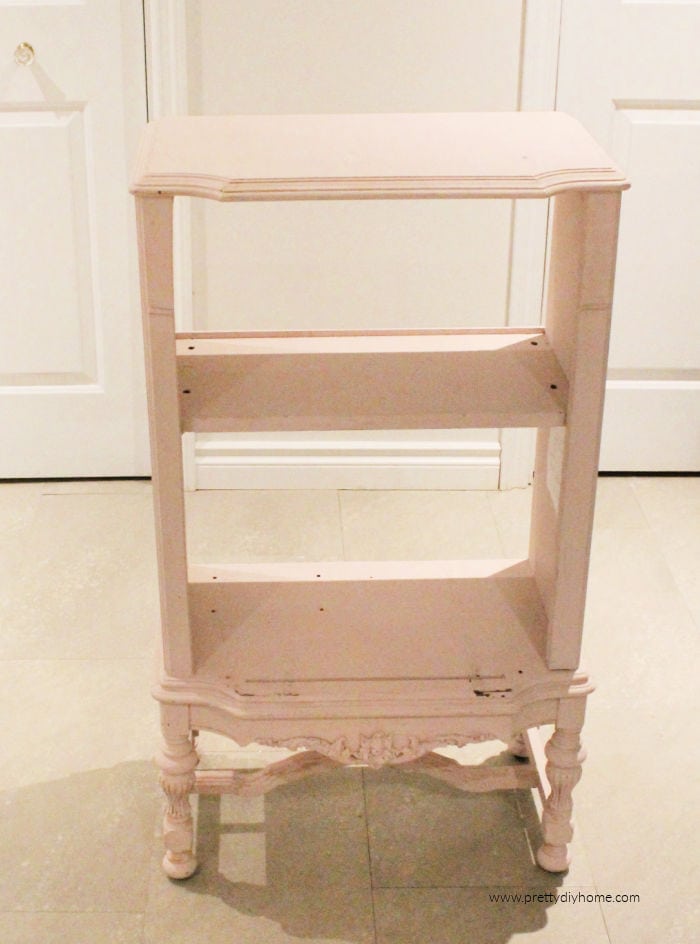 The before picture of a blush chalk painted antique cabinet