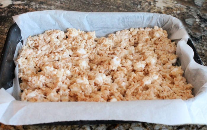 The first layer of layered rice krispie square recipe.