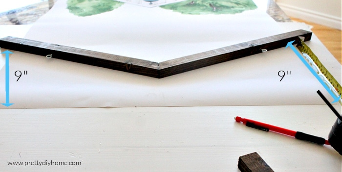 Placing a wooden poster frame on the top of a printed poster.