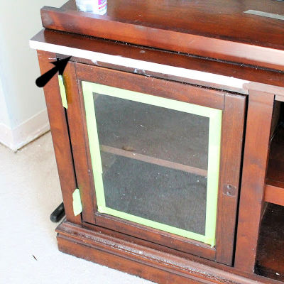 Repair of damaged laminate on an entertainment center.