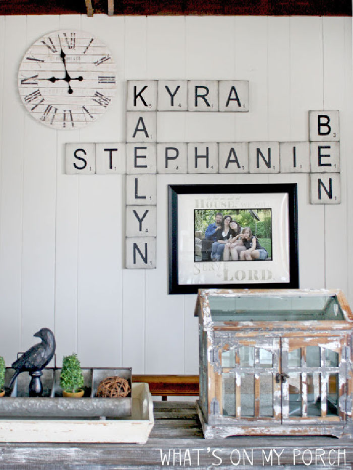 Wall decor made with DIY scrabble pieces, the scrabble letters spell out the families names