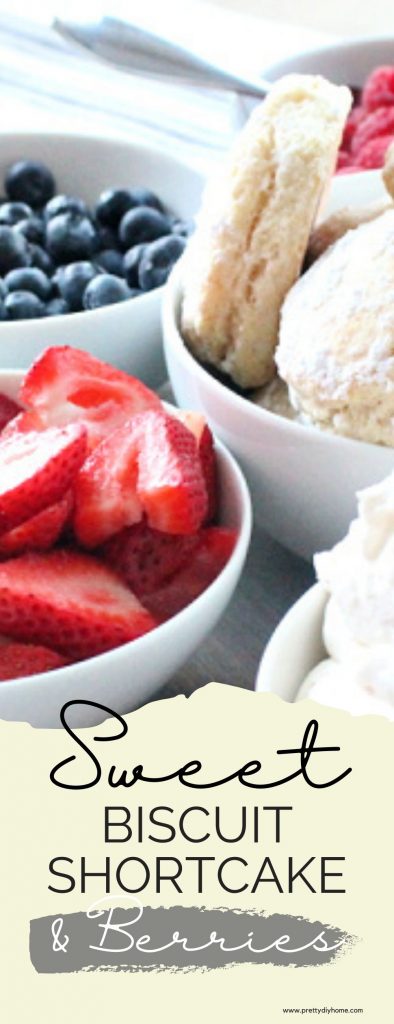 Bowls of fresh berries, fresh sweet whipped cream. and sweet biscuits on a tray for serving as homemade strawberry shortcake with biscuits.