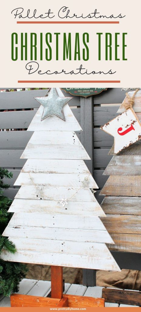 Two DIY pallet wood Christmas tress painted in chippy white paint finish for a rustic farmhouse look. They two wood Christmas trees are outside surrounded by faux trees and a tree farm sign.
