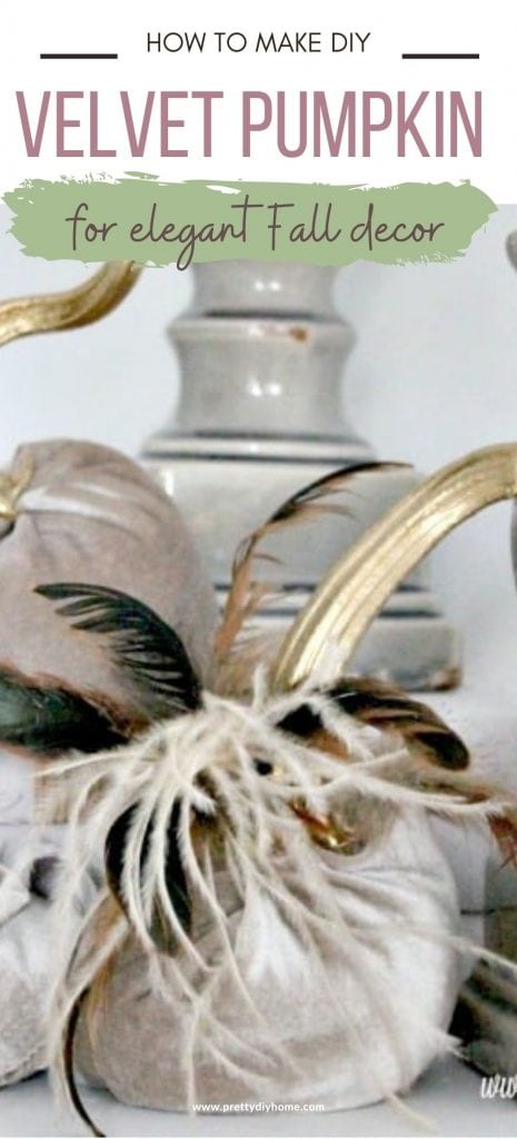 Three DIY velvet pumpkins with feathers and gold stems, in a Fall decor arrangement with candles.