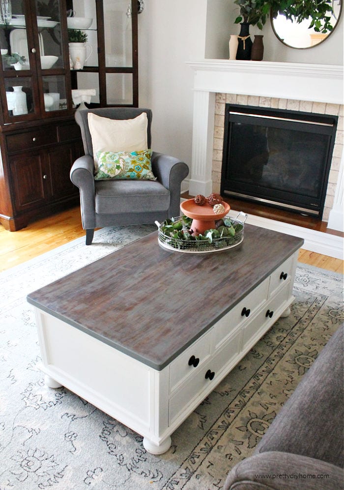 A greige restoration hardware finish on a DIY coffee table makeover. The table top is greige and the sides are bright white.