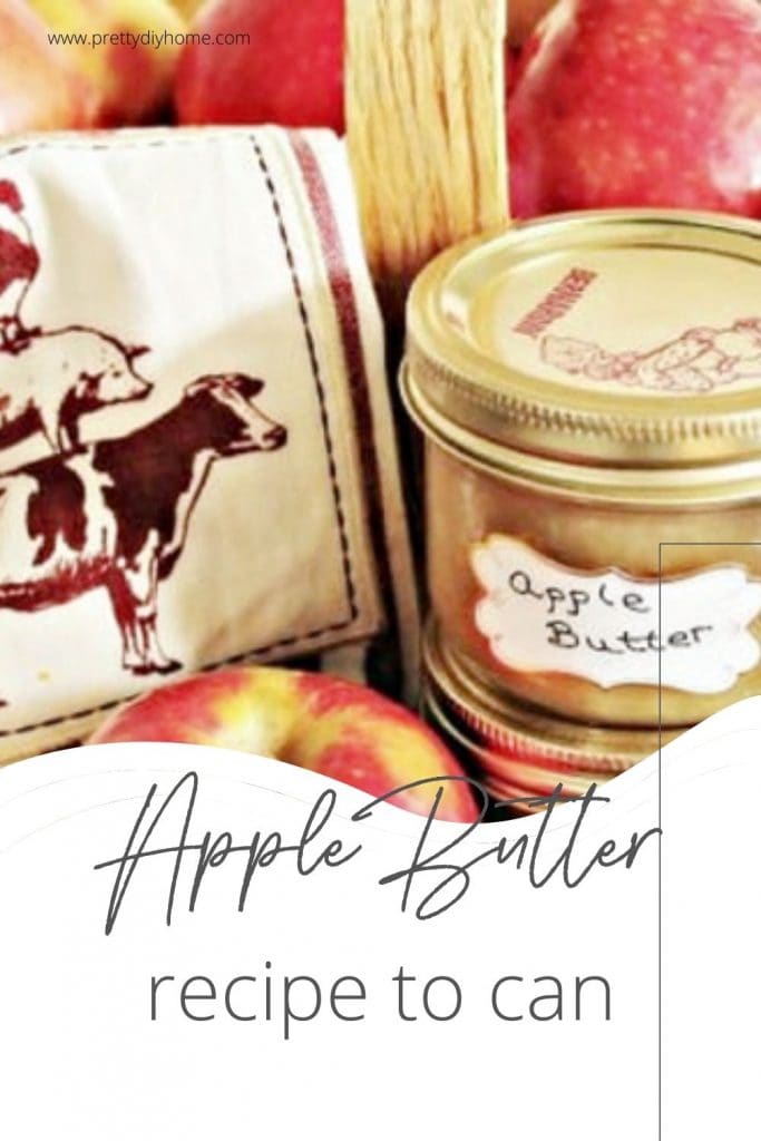 A jar of canned apple butter. The jar is open so you can see the apple butter and there is a spoon in the jar for serving.