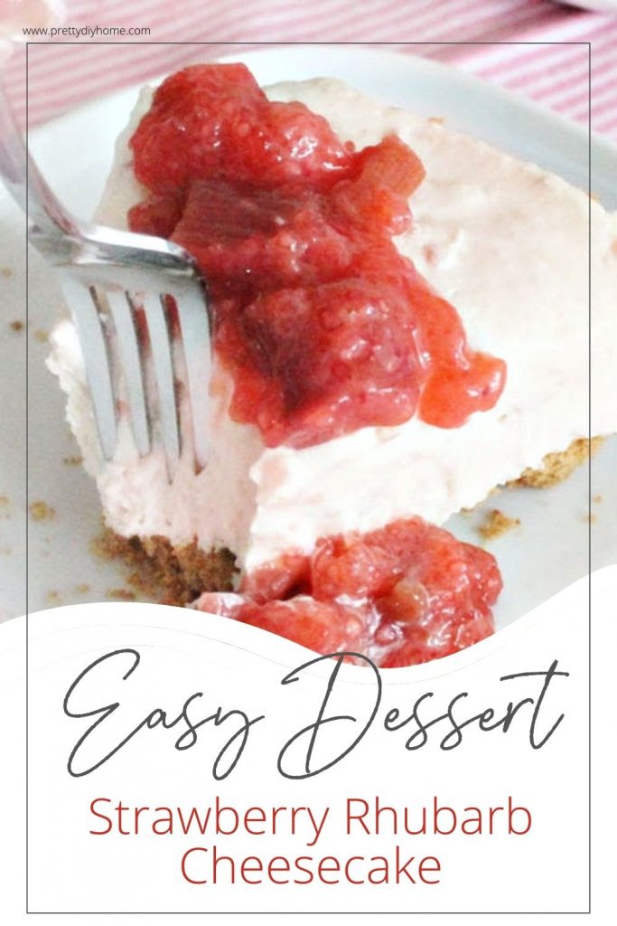 An easy dessert idea with strawberry and rhubarb. A slice of no bake cheesecake with a soft pink filling thats drizzled with dark red strawberry and rhubarb sauce.