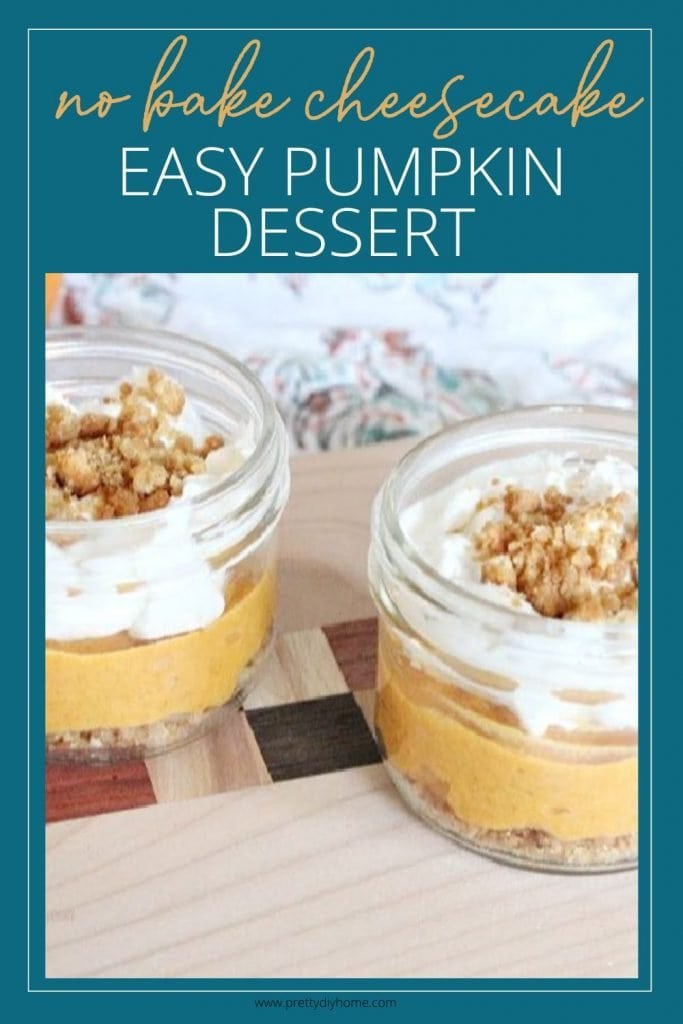 A image of two no bake single serving pumpkin cheesecakes in clear jars that show the pretty layers of crumbs, pumpkin, whipped cream and cookie crumbs. The picture has a dark teal backrop