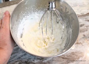 A large mixing bowl full of freshly made whipped cream.