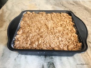 How to Make Pumpkin Spice Cake Preheat the oven to 350. Grease a square 8 inch pan. Line the bottom with parchment paper. We will start by mixing together each layer of the pumpkin dessert, then put it all together at the end before placing it in the oven. This is a great recipe with layers that bake all together. Step 1 - Mixing Pumpkin Cake Batter In a large bowl, combine the wet ingredients, pumpkin, egg, sugar, oil, and vanilla in a mixing bowl. In a second bowl stir together the dry ingredients, flour, salt, soda, baking powder, and spices. Set aside. Step 2 - Cream Cheese Layer In a medium bowl with the paddle attachment, mix the cream cheese, and white sugar, and beat until creamy. Add the vanilla extract, mix again, and set aside. Step 3 -Mixing Streusel Layer In a separate bowl mix the butter with the two sugars until blended. Add the flour, then add the baking powder and spices to the flour mixture. Mix until the crumbs are the size of small peas. Set aside. Step 4 - Assembling the Pumpkin Cake Layers This pumpkin is a bit different than other sheet cakes, the layers are all placed onto the cake sheet and baked at once. For the pumpkin cake bottom layer, mix the dry ingredients into the pumpkin mixture. Mix until just combined and transfer the wet batter to the 8 by 8-inch prepared pan. Spread evenly. For the middle cream cheese frosting layer. Place spoonfuls of the cream cheese mixture over the pumpkin batter. Lightly spread the cream cheese over the pumpkin batter in a thin layer, making sure not to combine the layers into a swirl. Place the streusel crumbs evenly over the top and place in the oven. Bake at 350 for 40-45 min Let cool before slicing.