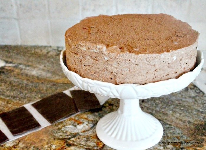 A nobake chocolate cheesecake being decorated for a special occasion.