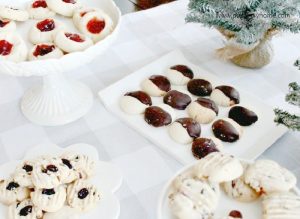 A display of different varieties of shortbread cookie recipes, there is shortbread dipped in chocolate, cranberry pistachio shortbread cookies, shortbread jam cookies and chocolate chip pecan shortbread cookies.