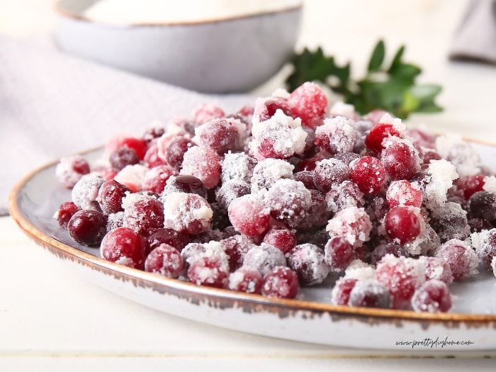 A dish of sugar coated cranberries waiting to be made into garnish with toothpicks.