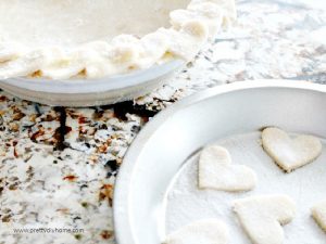 Pie crust cut in heart shapes for making Valentines dessert there is also a pie with Valentine heart shapes all around the crust.