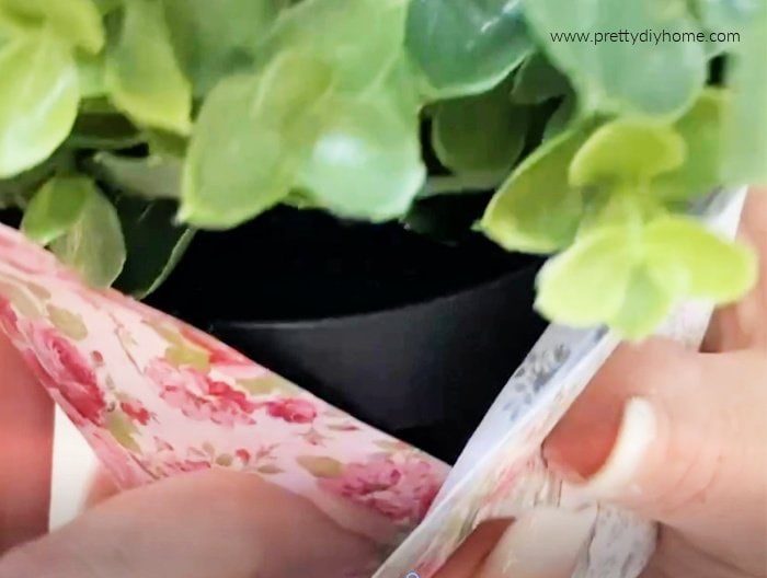 Wrapping the front of a plant pot for making a Valentine's day gift idea. The paper is pink and blue florals.