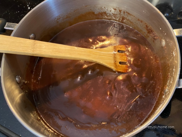 Butter, chocolate, sugar and cream cooking together over the stove, while making an Easter treat.