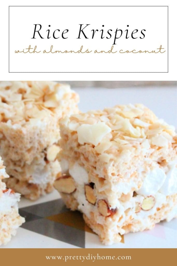 A close up of a rice krispie treats showing a thick center of marshmallows, almonds and coconut.