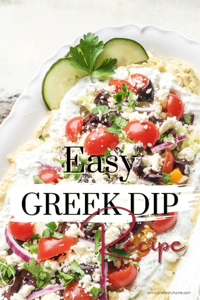 Easy to make Greek dip with hummus, tzatziki, red onions, cheery tomatoes and feta cheese crumbles served on a white platter with a granite counter backdrop.