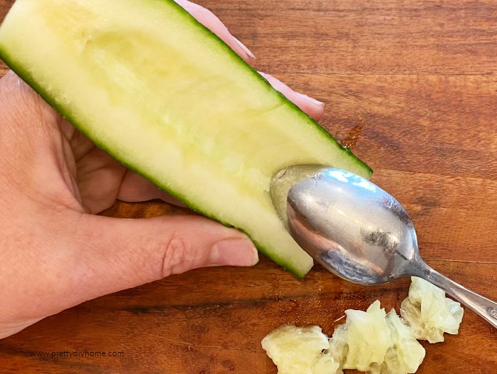 Removing cucumber seeds with a spoon for homemade tzatzik.
