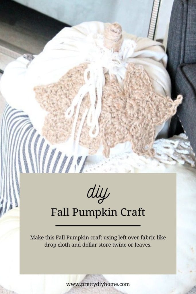 A large dropcloth pumpkin with a burlap twine steam and large crocheted pumpkin leaves made using twine.