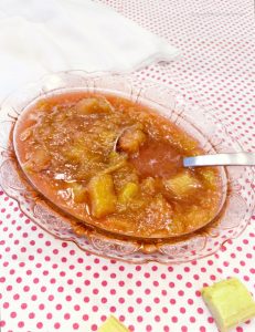 Homemade rhubarb sauce being served in a pink bowl.