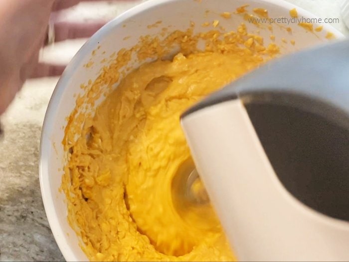 Blended pumpkin mousse for pumpkin dessert. The mousee is being beaten with a mixer.