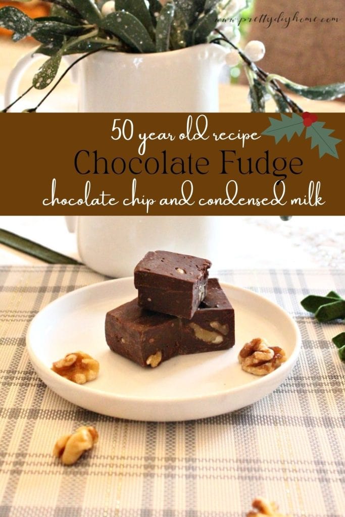 Three pieces of homemade fudge sitting on a white plate being served as a Christmas treat. The chocolate fudge is dark brown with chunks of walnuts, and there are walnuts sitting on the plate as well.