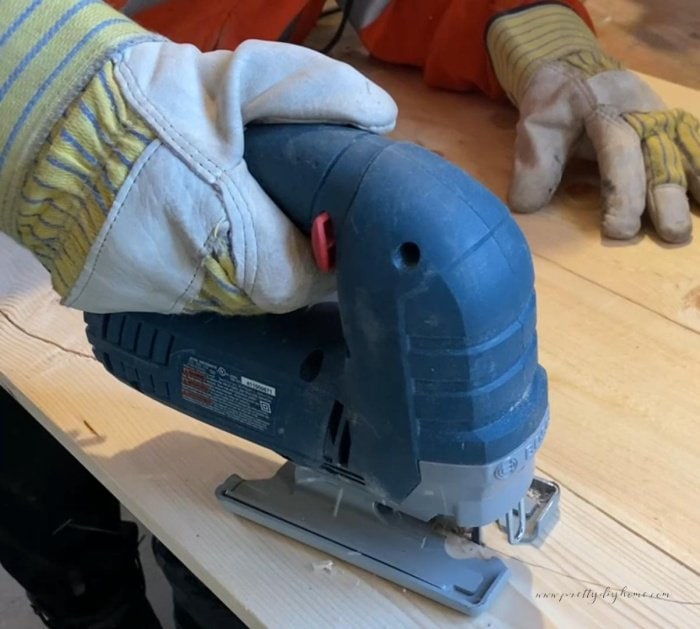 Cutting out a large wooden bunny with a jigsaw.