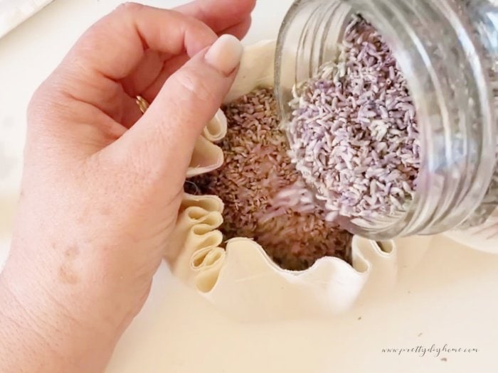 Filling a diy pincushion with lavender seeds.