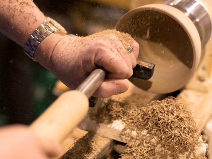 A wooden bowl being made on a lathe.