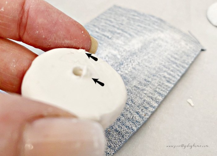 Sanding rough bits off of a DIY clay bead