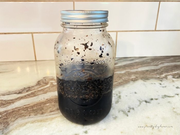 A mason jar filled with cold brew coffee steeping.