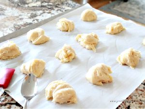 A tray of cream puff shells being made for cream puffs.