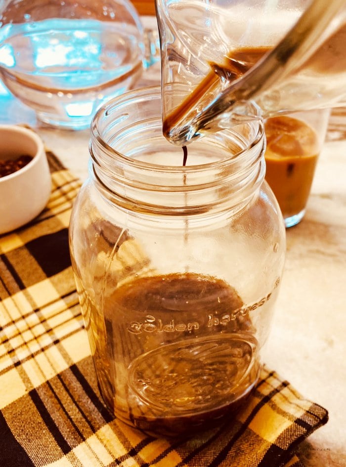 Storing leftover cold brew coffee concentrate in a mason jar.