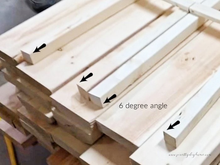 The four legs of a DIY obelisk cut at a 6 degree angle