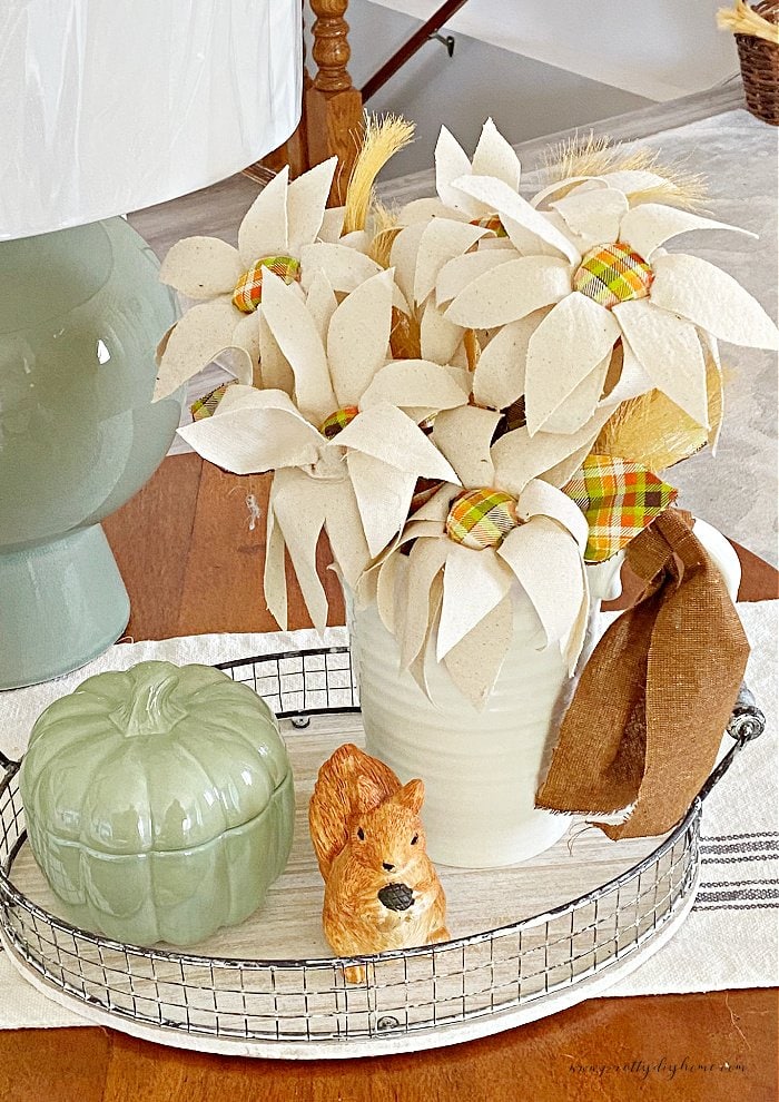 A bouquet of DIY fabric flowers in cream with orange plaid center for Fall decor.