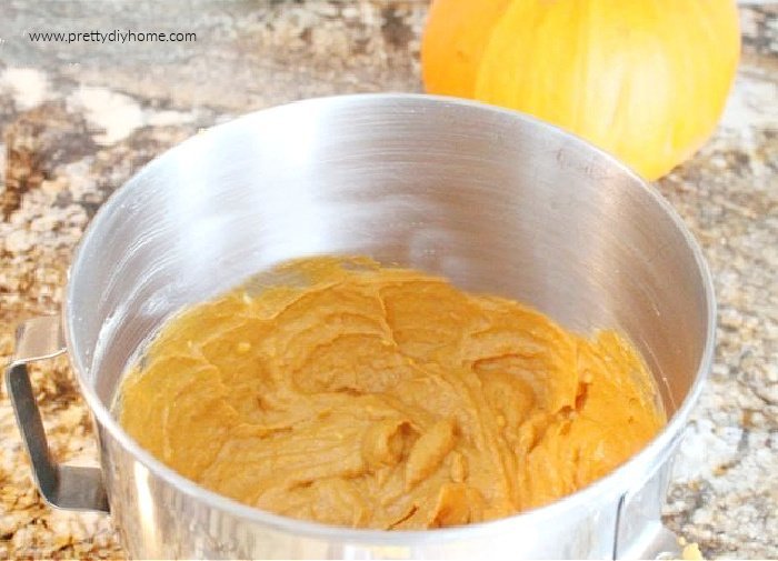 Pumpkin cream cheese filling in a mixing bowl.  The cream cheese and pumpkin filling is ready to be added to the pumpkin cheesecake recipe.