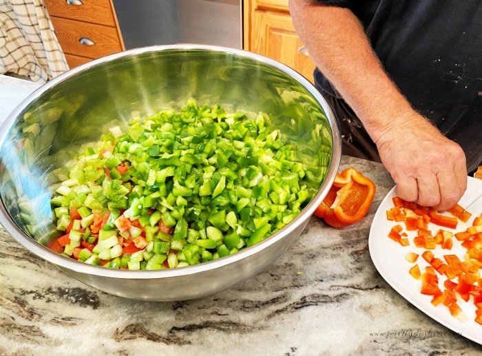 Chopping peppers for making a large homemade salsa canning recipe.