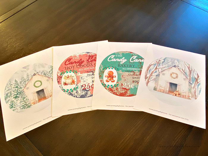 Four different printables that are each round for adding to the back of a pie plate. Two are wintery Christmas scenes with white barns the other two are a candy cane hot cocoa sign and a candy cane bakery sign printable.